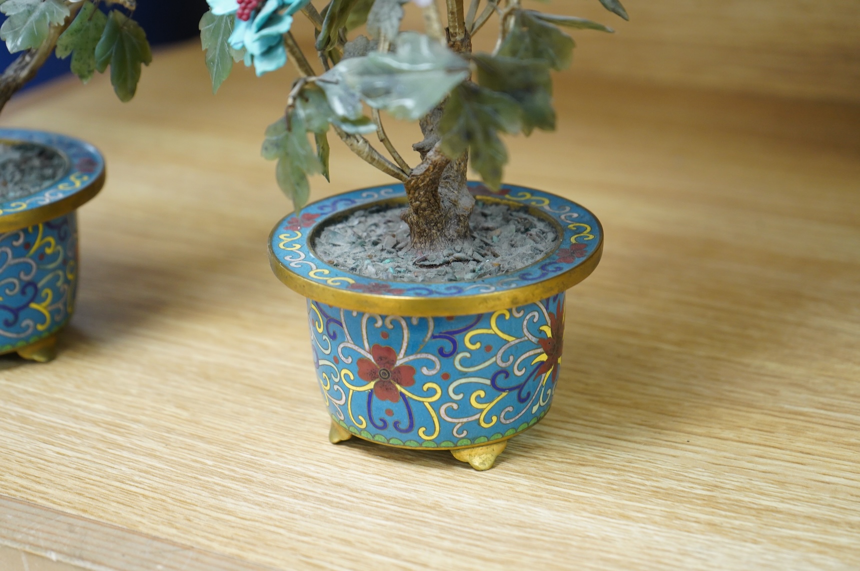 A pair of Chinese hardstone trees, in cloisonne jardinieres, 23cm high